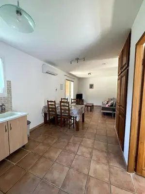 a kitchen and dining room with a table and chairs at Résidence Kallisté in Sollacaro