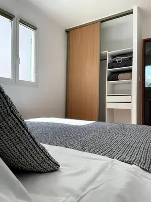 a bedroom with a bed and a closet at Résidence Kallisté in Sollacaro