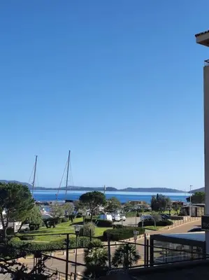 a view of a park with the ocean in the background at Appartement sur le port Résidence Marina Palmu in Porto-Vecchio