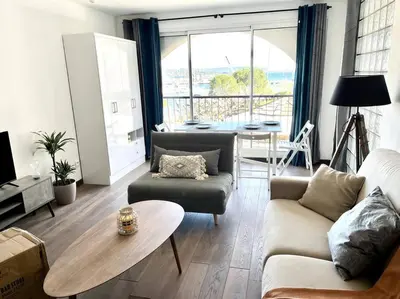 a living room with a couch and a table at Appartement sur le port Résidence Marina Palmu in Porto-Vecchio