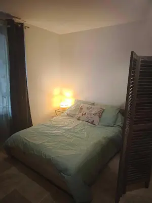 a small bedroom with a bed with a lamp on it at Casa di Mela in Mela