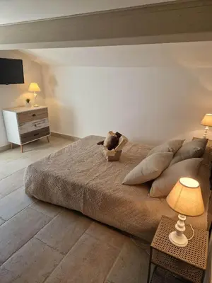 a bedroom with a large bed with a stuffed animal on it at Casa di Mela in Mela
