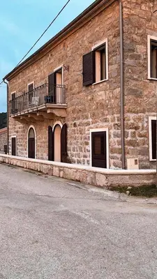 a large brick building with windows and a balcony at Casa di Mela in Mela