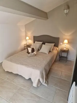 a bedroom with a large bed with two lamps at Casa di Mela in Mela