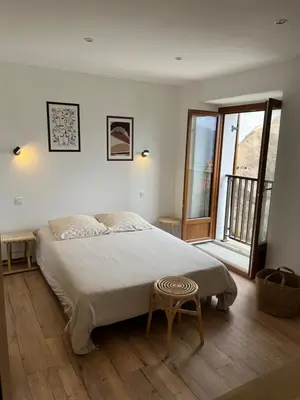 a bedroom with a bed with a stool in it at Maison Casa Amarina in Olmeto