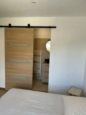 a bedroom with a white bed and a window at Maison Casa Amarina in Olmeto