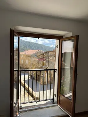 an open door to a balcony with a view at Maison Casa Amarina in Olmeto