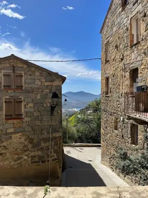 an entrance to an old stone building with a street at Maison Casa Amarina in Olmeto