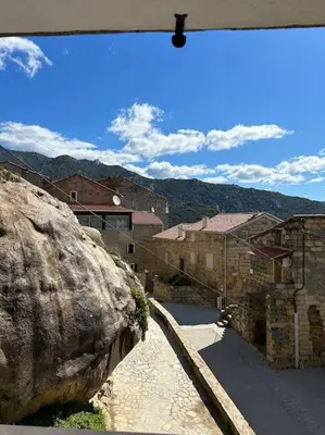 a view of a city with a large rock at Maison Casa Amarina in Olmeto