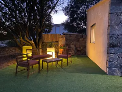 two red chairs and a pool in a yard at Chez François et Cécile in Figari