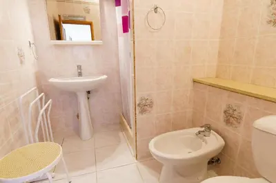a small bathroom with a sink and a toilet at La Caletta Corsa Apartments - 2 Camere con Terrazza Privata, Aria Condizionata, 100m dal Mare in Linguizzetta