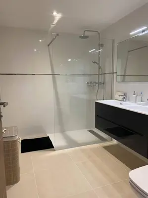 a bathroom with a glass shower and a sink at T2 neuf 4 personnes avec piscine/terrain tennis in Porto-Vecchio