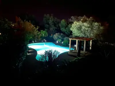 a swimming pool at night with a gazebo at Luxueuse Villa, Hyper centre PORT de PORTO VECCHIO in Porto-Vecchio