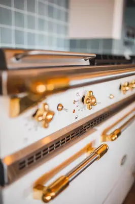 a bunch of gold objects on top of an oven at Les Demeures de Piana in Piana