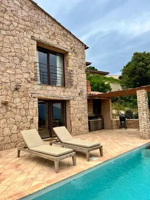 a villa with a swimming pool and a house at Les Demeures de Piana in Piana