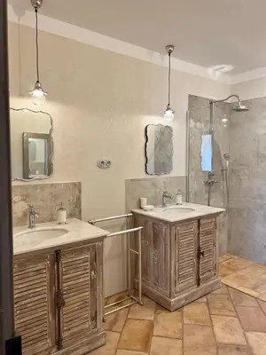 a bathroom with two sinks and a shower at Les Demeures de Piana in Piana