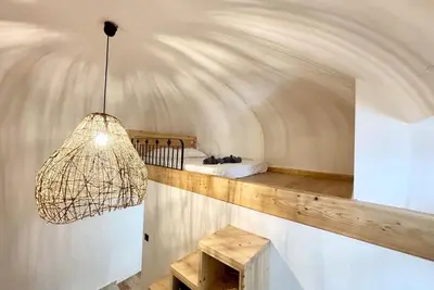 a room with a bed and a pendant light at Casamea - Vue Mer, Centre Ajaccio, Clim & WiFi in Ajaccio