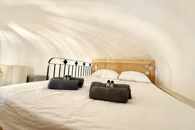 a bedroom with two pillows on a white bed at Casamea - Vue Mer, Centre Ajaccio, Clim & WiFi in Ajaccio