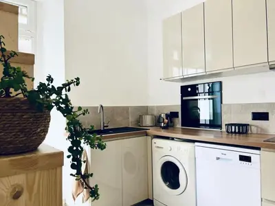 a kitchen with a washing machine and a washer at Casamea - Vue Mer, Centre Ajaccio, Clim & WiFi in Ajaccio