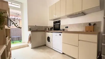 a kitchen with a washer and dryer in it at Casamea - Vue Mer, Centre Ajaccio, Clim & WiFi in Ajaccio