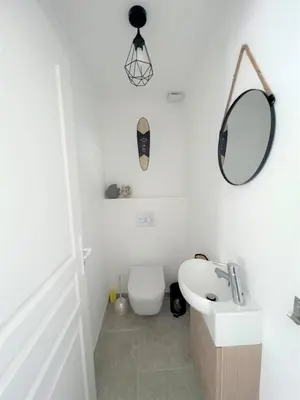 a bathroom with a toilet and a sink and a mirror at Casa Vecchia Di Olmuccio in Sainte-Lucie de Porto-Vecchio
