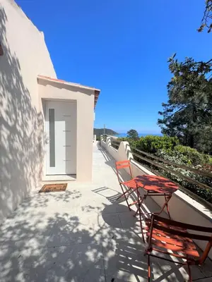a pair of chairs sitting on a balcony at Casa Vecchia Di Olmuccio in Sainte-Lucie de Porto-Vecchio