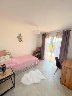 a bedroom with a bed and a table and a chair at Casa Vecchia Di Olmuccio in Sainte-Lucie de Porto-Vecchio