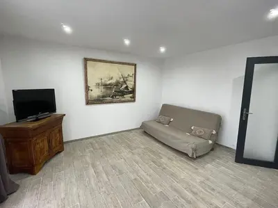 a living room with a couch and a flat screen tv at U Secondu Appart neuf spacieux au calme in Aléria