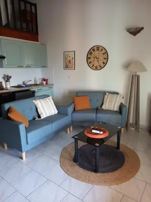 a living room with two blue couches and a table at CASA DI PETRU ANTÒ in Serra-di-Ferro