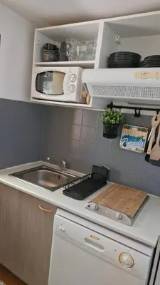 a small kitchen with a sink and a stove at mini villa 72, résidence avec piscine. in Serra-di-Ferro
