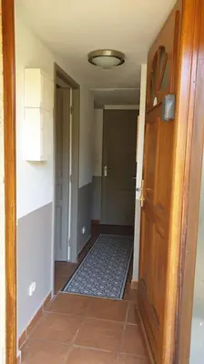 a hallway with a door leading into a room with a hallway at mini villa 72, résidence avec piscine. in Serra-di-Ferro