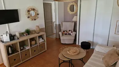 a living room with a couch and a table at mini villa 72, résidence avec piscine. in Serra-di-Ferro
