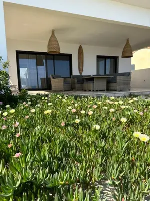 a house with a lot of flowers in front of it at Maison les pieds dans l’eau in Ghisonaccia