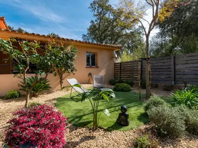 a garden with a fence and a chair in a yard at Holiday Home Casa Brigitte by Interhome in Sainte-Lucie de Porto-Vecchio