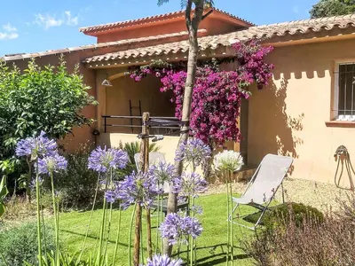 a garden with purple flowers in front of a house at Holiday Home Casa Brigitte by Interhome in Sainte-Lucie de Porto-Vecchio