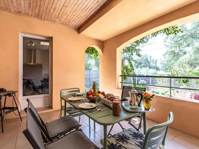 a dining room with a table and chairs on a balcony at Holiday Home Casa Brigitte by Interhome in Sainte-Lucie de Porto-Vecchio