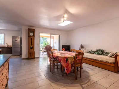 a living room with a table and a couch at Holiday Home Casa Brigitte by Interhome in Sainte-Lucie de Porto-Vecchio