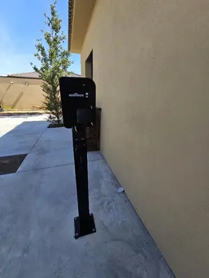 a parking meter sitting on the side of a building at Résidence Villas Chléa in Lucciana