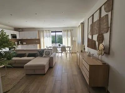 a living room with a couch and a table at Résidence Villas Chléa in Lucciana