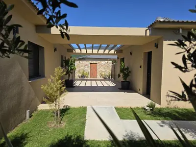 a house with a pathway leading to the front door at Résidence Villas Chléa in Lucciana