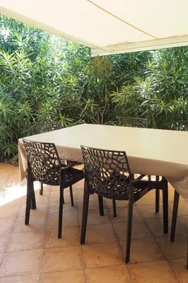 a table and chairs sitting under an umbrella at Villa tout confort avec piscine privée in Ventiseri