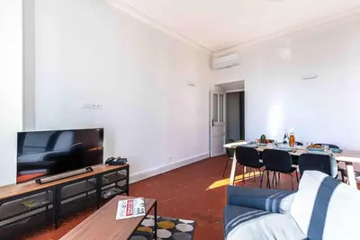 a living room with a couch and a tv at Appartement Ajaccien familial in Ajaccio