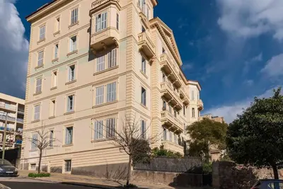a large white building on a city street at Appartement Ajaccien familial in Ajaccio
