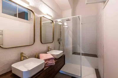 a bathroom with a sink and a shower at Appartement Ajaccien familial in Ajaccio