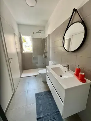 a bathroom with a sink and a toilet and a mirror at Studio 173 - Ajaccio - Campagne in Ajaccio
