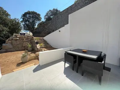 a black table and chairs on a patio at Studio 173 - Ajaccio - Campagne in Ajaccio