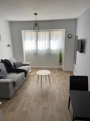 a living room with a couch and a table at Résidence City Suites Ajaccio in Ajaccio