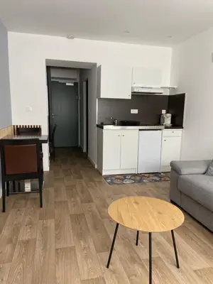 a living room with a couch and a table at Résidence City Suites Ajaccio in Ajaccio