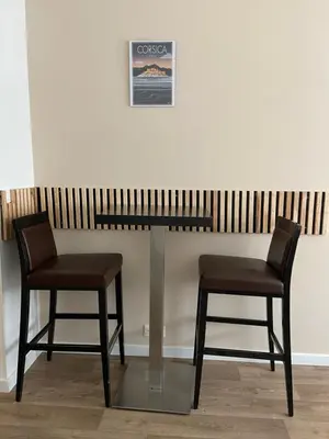 two chairs and a table in a room at Résidence City Suites Ajaccio in Ajaccio
