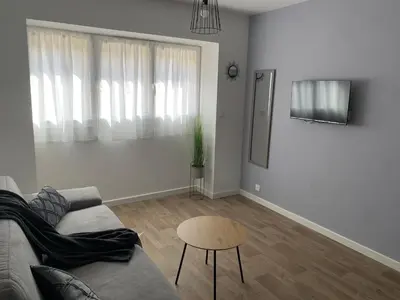 a living room with a couch and a table at Résidence City Suites Ajaccio in Ajaccio